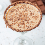 A chocolate martini with chocolate shavings.