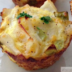 Closeup of a Muffin Tin Egg Bites with Potato Slices.
