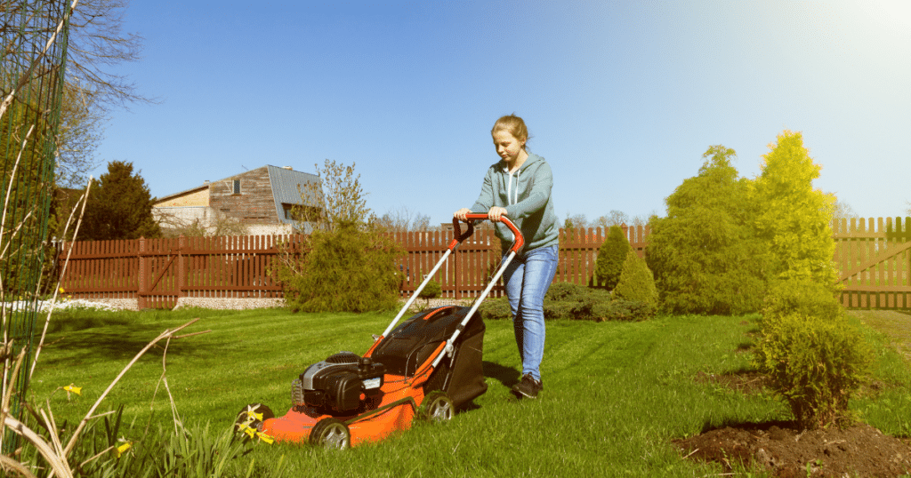 Preteen girl mowing the lawn.