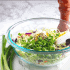 Ingredients for homemade coleslaw in a bowl with a pepper grinder sitting beside the bowl
