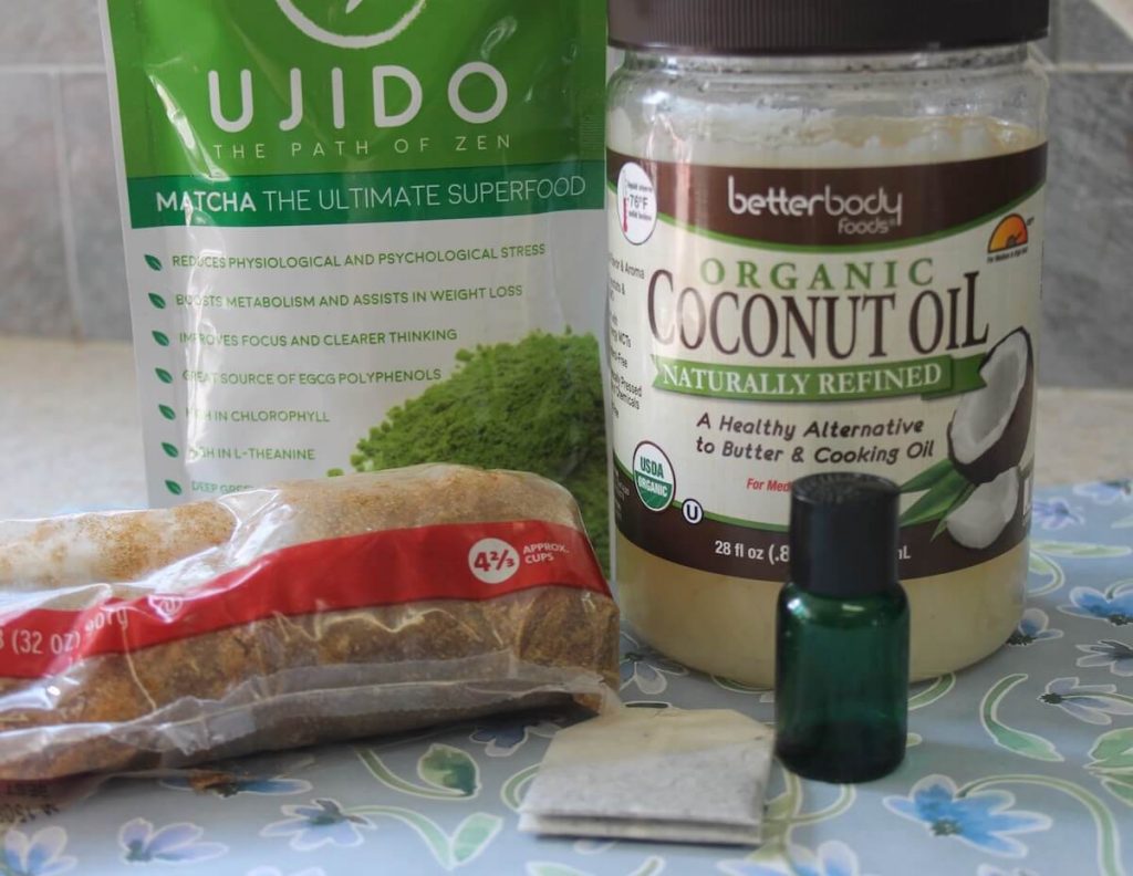 Ingredients for making Brown Sugar Scrub with Green Tea & Peppermint: matcha power, brown sugar, coconut oil, peppermint essential oil, and green tea bag.