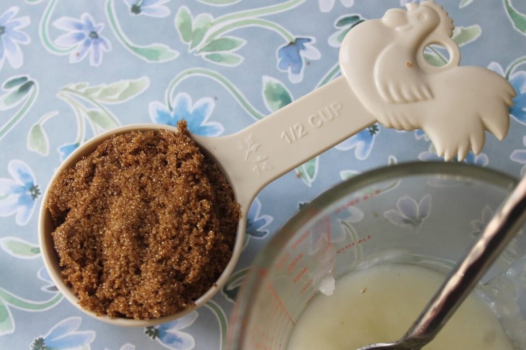 Brown sugar in a measuring spoon for Brown Sugar Scrub with Green Tea & Peppermint