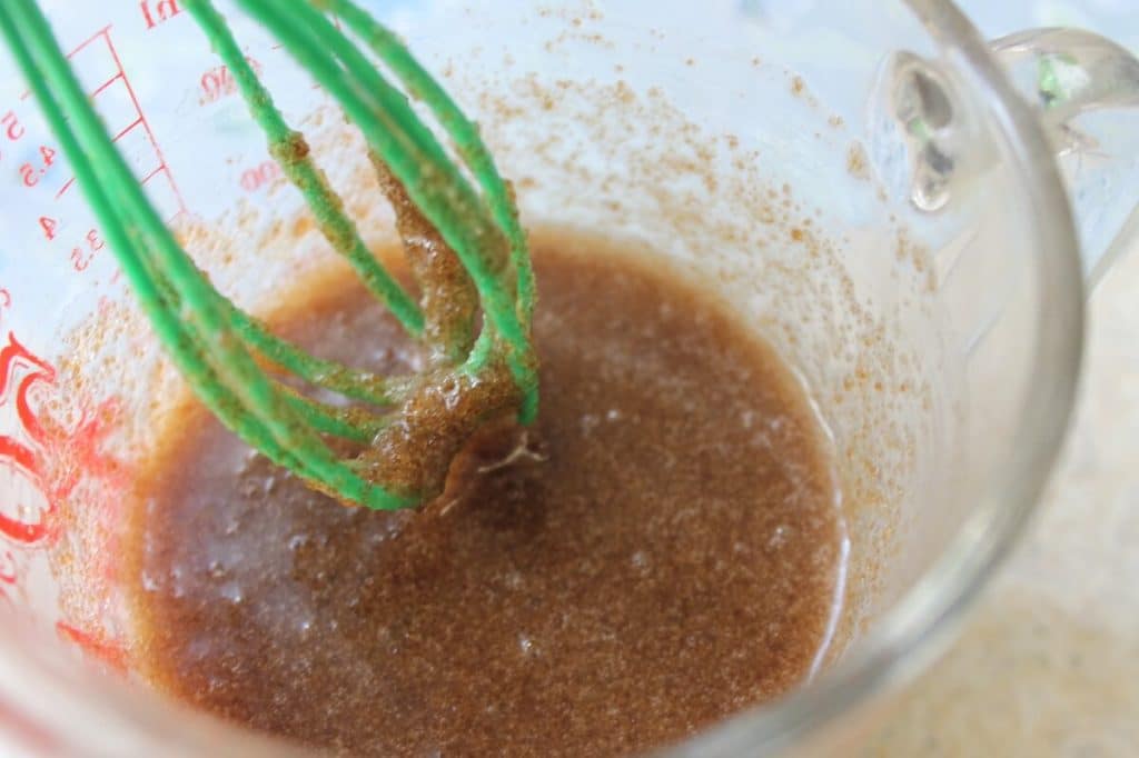 Brown sugar and coconut oil in a measuring cup - step 2 of making Brown Sugar Scrub with Green Tea & Peppermint.