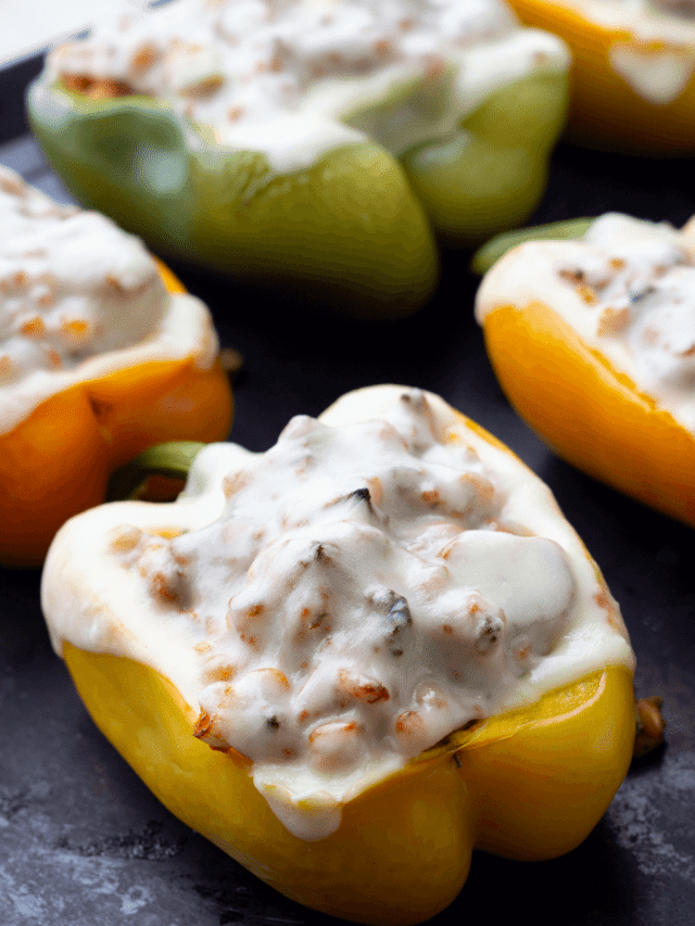 Yellow, orange, and green bell peppers stuffed with ground turkey and barley, topped with melted cheese.