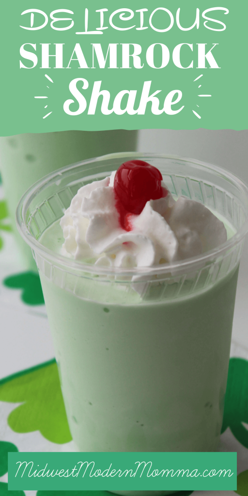 A homemade shamrock shake in a plastic cup with whipped cream and a cherry on top.