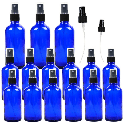 15 cobalt blue spray bottles on a white background.