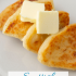 Scottish tattie scones on a plate with butter, with text reading Scottish Potato SCoens