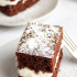 Creamy marshmallow filling between two slices of devils food cake, with text naming the recipe a copycat Hostess Suzy Q.