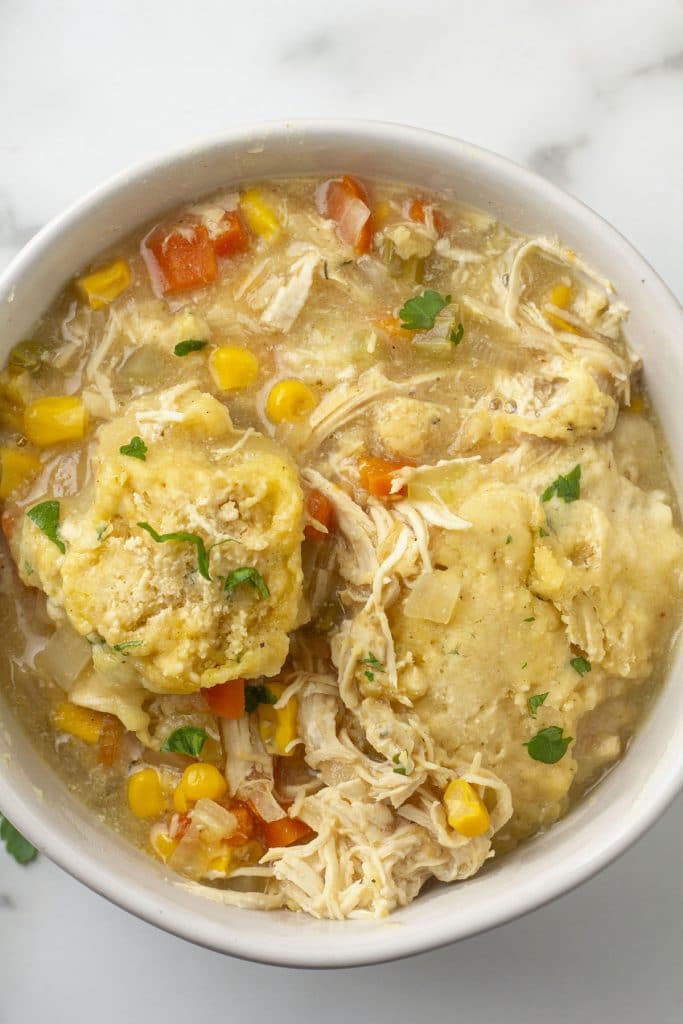 Chicken and dumpling soup in a white bowl.