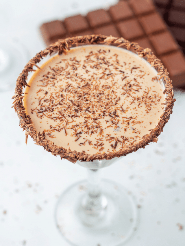 A chocolate martini with chocolate sprinkles and chocolate bars.