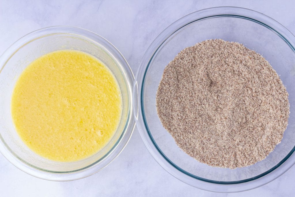 One bowl with the wet ingredients and bowl with the sifted dry ingredients for gluten-free cornbread.