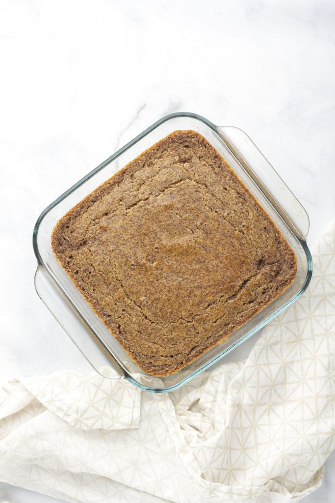 A glass pan of paleo cornbread.