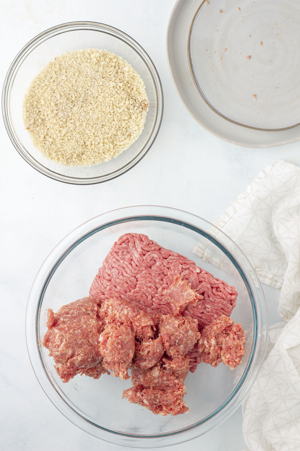 Ground meat for square sausage in a glass bowl.