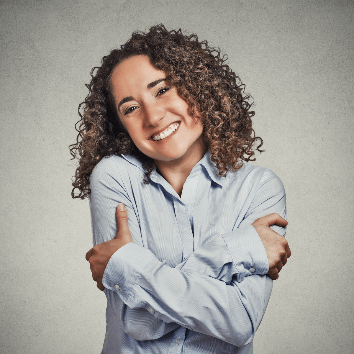 Woman hugging herself.