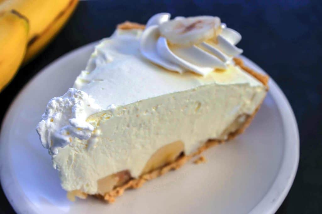 A slice of banana cream pie on a plate.