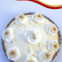 Whole banana pudding pie with text overlay describing recipe.