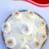 Whole banana pudding pie with text overlay describing recipe.