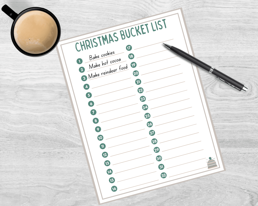 A partially completed Christmas bucket list printable is on a surface with a pen and cup of coffee.