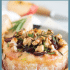 Cranberry baked brie with honey, walnuts, and rosemary with text describing the image.