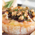 Cranberry baked brie with honey, walnuts, and rosemary with text describing the image.