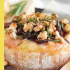 Cranberry baked brie with honey, walnuts, and rosemary with text describing the image.