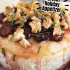 Cranberry baked brie with honey, walnuts, and rosemary with text describing the image.