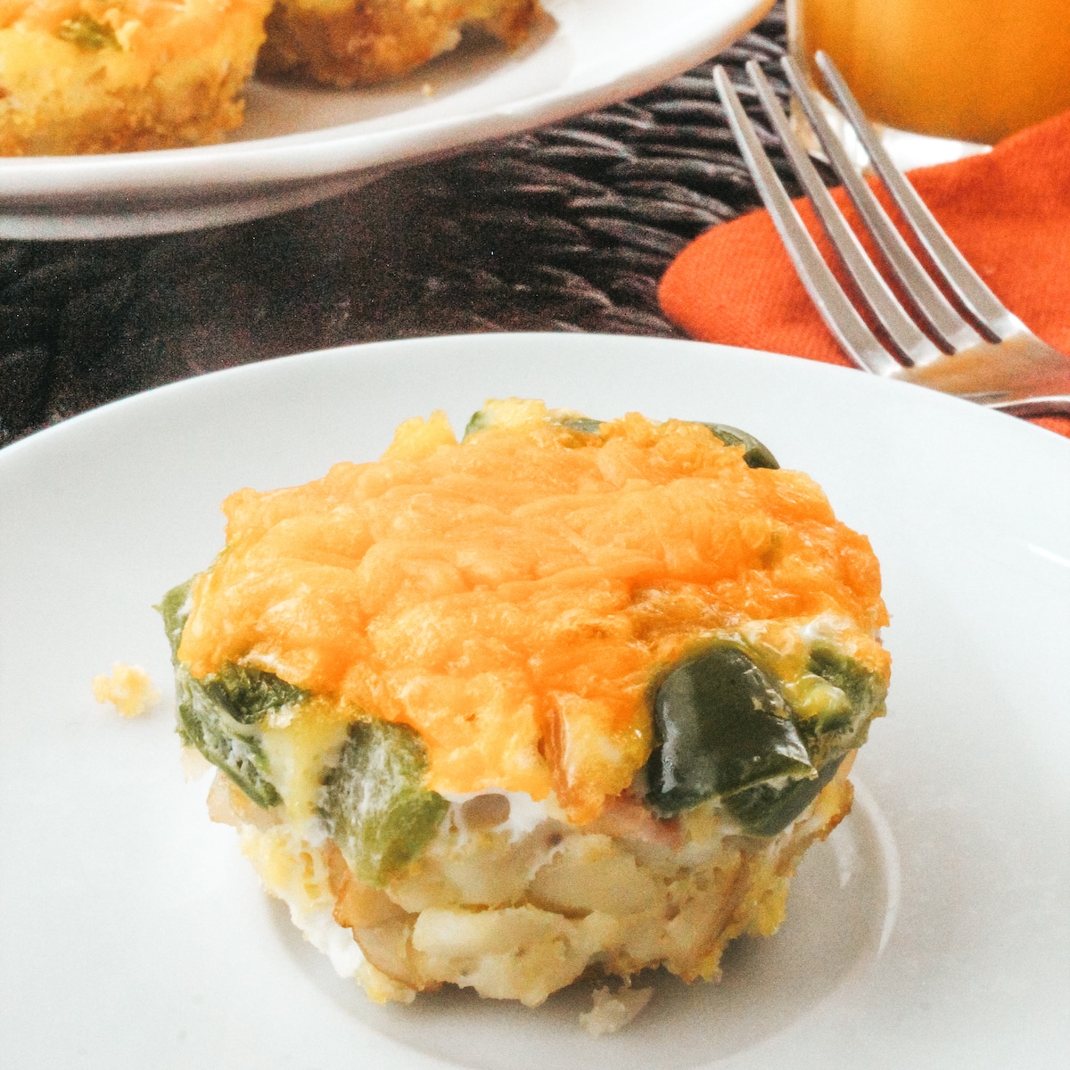 Closeup of an egg muffin on a white plate.