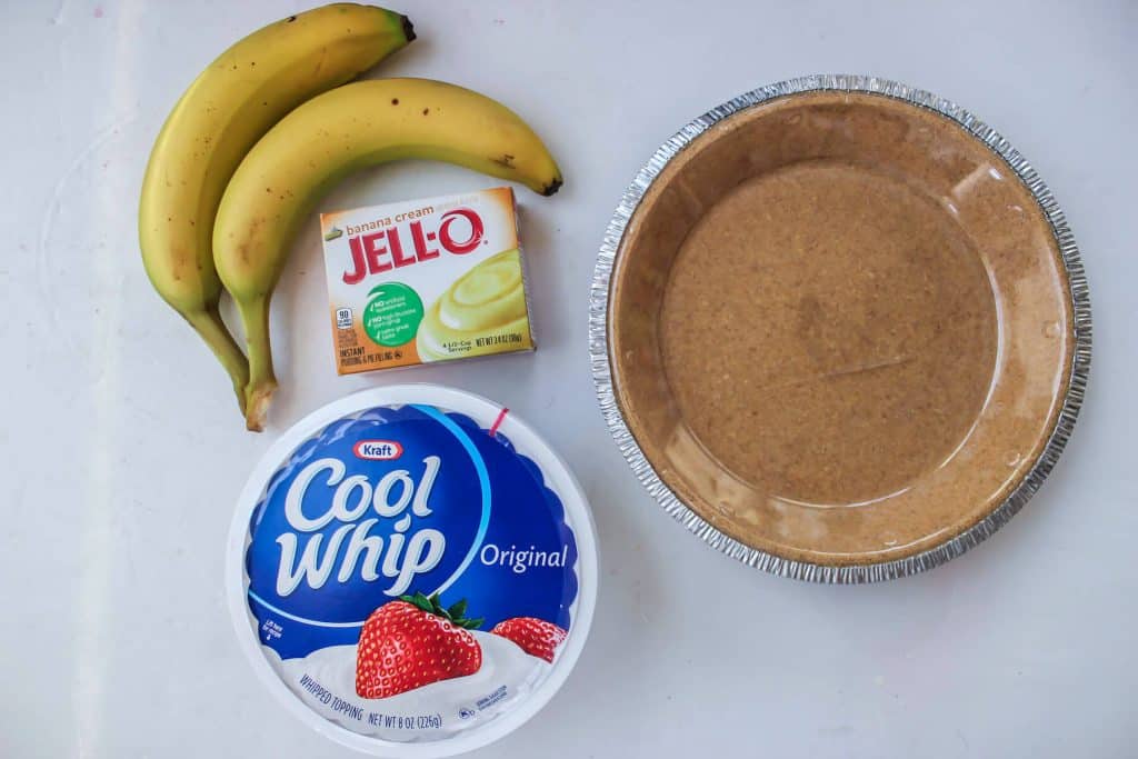 Bananas, a box of pudding mix, a tub of cool whip, and a premade graham cracker pie crust.